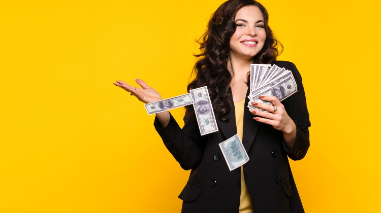 free money offers, woman on a yellow background holding money